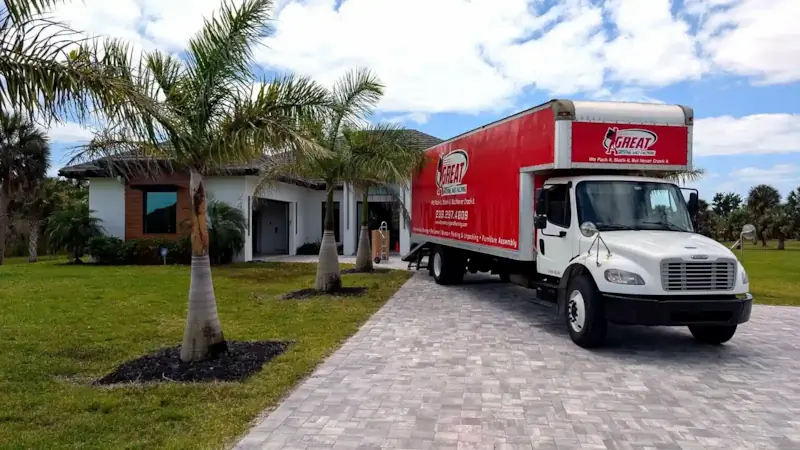 Great Moving & Packing truck on a Southwest Florida residential street — licensed local movers, (239) 297-4809